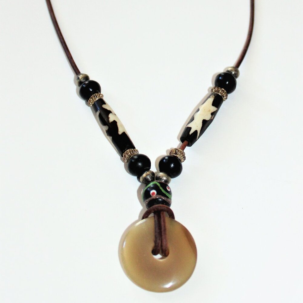 An Earthy 30 mm  Blond Horn Donut Strung  on 2 mm Distressed Leather